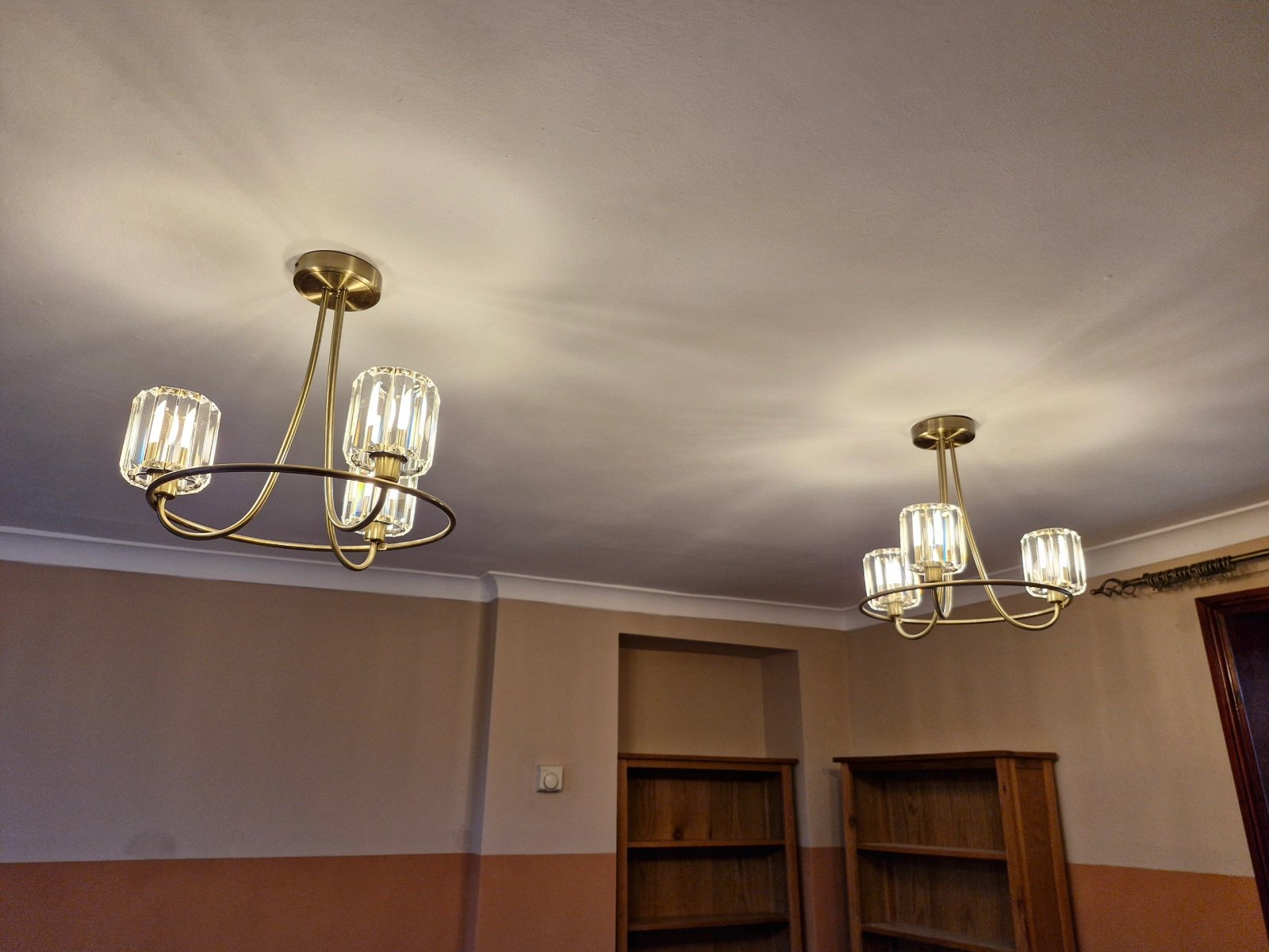 Matched brass and glass pendant lights installed in a Norfolk dining room by Acorn